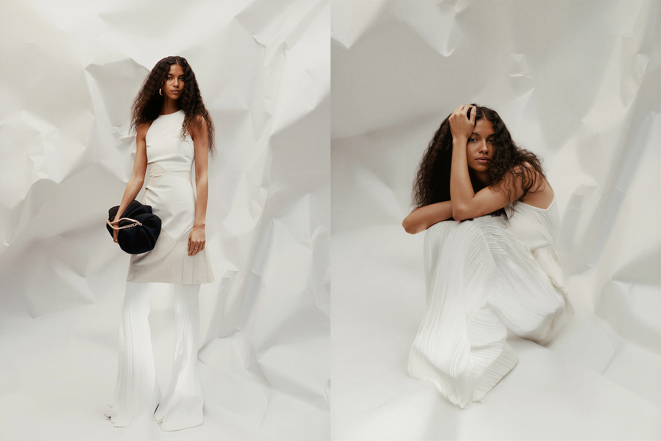two women in white clothing posing on a crumpled high-fashion background